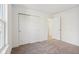 An open bedroom with carpet features a double door closet and white trim throughout at 1669 Windrush Pl, Westfield, IN 46074
