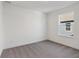 A bright bedroom features neutral carpet, white walls and trim, and a window offering natural light at 1669 Windrush Pl, Westfield, IN 46074