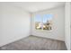 Bright, carpeted bedroom with white walls and a large window with a neighborhood view at 1669 Windrush Pl, Westfield, IN 46074