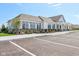 View of the clubhouse with ample parking spaces and well-manicured landscaping at 1669 Windrush Pl, Westfield, IN 46074
