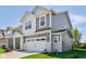 Stylish home with gray siding, a white garage door, and a meticulously maintained lawn at 1669 Windrush Pl, Westfield, IN 46074