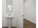 Bathroom featuring a pedestal sink and mirror at 1669 Windrush Pl, Westfield, IN 46074