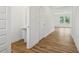 Hallway with wood floors, a pedestal sink in half bath, and natural light at 1669 Windrush Pl, Westfield, IN 46074