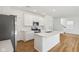 Bright kitchen with white cabinets, a stainless steel microwave, and a kitchen island at 1669 Windrush Pl, Westfield, IN 46074