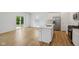 Bright kitchen with stainless steel appliances, island with sink, and adjacent dining area and sliding door at 1669 Windrush Pl, Westfield, IN 46074