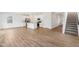 Open-concept living space featuring light wood floors, a modern kitchen, and a staircase at 1669 Windrush Pl, Westfield, IN 46074
