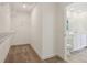 A walk-in closet is equipped with shelving and an open door to the Primary bathroom at 1669 Windrush Pl, Westfield, IN 46074