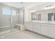 Bright bathroom with glass enclosed shower, double sinks, and luxurious countertops. Perfect for a spa day at home at 1694 Windrush Pl, Westfield, IN 46074