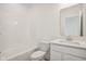 Clean, white bathroom with tub, toilet, and vanity with bright mirror. Perfect for a fresh start each day at 1694 Windrush Pl, Westfield, IN 46074