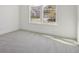 Empty bedroom featuring carpet flooring, white walls and a window overlooking the street at 1694 Windrush Pl, Westfield, IN 46074