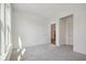 Bright bedroom featuring plush carpeting, an open doorway, and plentiful natural light from a large window at 1694 Windrush Pl, Westfield, IN 46074