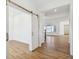Open floor plan with wood flooring, barn doors and bright white walls at 1694 Windrush Pl, Westfield, IN 46074