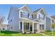 Attractive two-story home featuring a covered front porch, manicured landscaping, and complementary exterior colors at 1694 Windrush Pl, Westfield, IN 46074