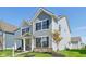 Well-maintained two-story home with a classic design, complemented by a green lawn and young trees at 1694 Windrush Pl, Westfield, IN 46074