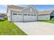Three-car garage with an extensive concrete driveway, perfect for ample parking and curb appeal at 1694 Windrush Pl, Westfield, IN 46074