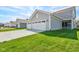 Spacious three-car garage with a wide driveway and lush green lawn enhancing curb appeal at 1694 Windrush Pl, Westfield, IN 46074