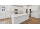 Modern kitchen with a large island, stainless steel appliances, and subway tile backsplash at 1694 Windrush Pl, Westfield, IN 46074