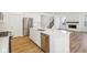 Well-appointed kitchen with stainless steel appliances, a large island and an open concept to the living area at 1694 Windrush Pl, Westfield, IN 46074