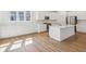 Open concept kitchen with stainless steel appliances, white cabinets and large island with seating at 1694 Windrush Pl, Westfield, IN 46074