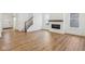 Bright living area with a fireplace and hardwood floors flowing into other rooms with natural light at 1694 Windrush Pl, Westfield, IN 46074
