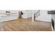 Spacious living area with modern kitchen, hardwood floors, and fireplace, complemented by natural light at 1694 Windrush Pl, Westfield, IN 46074