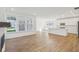 Open-concept living space blending kitchen and living room with hardwood floors and abundant natural light at 1694 Windrush Pl, Westfield, IN 46074