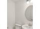 Contemporary powder room featuring modern fixtures, a sleek round mirror and bright lighting enhancing the space at 1694 Windrush Pl, Westfield, IN 46074