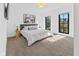 Bright bedroom with large windows, stylish decor, and neutral carpeting at 1818 N Pennsylvania St, Indianapolis, IN 46202