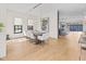 Open-concept dining room with hardwood floors, modern lighting, and a view into the kitchen at 1818 N Pennsylvania St, Indianapolis, IN 46202
