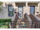Close-up of the home's front entrance showcasing brick stairs, a decorative door, and black trim windows at 1818 N Pennsylvania St, Indianapolis, IN 46202