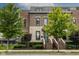 Charming multi-story brick home featuring manicured landscaping and a gated entry at 1818 N Pennsylvania St, Indianapolis, IN 46202