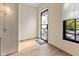Bright foyer featuring hardwood floors, stylish wallpaper, and a sleek front door design at 1818 N Pennsylvania St, Indianapolis, IN 46202
