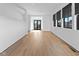 Open living area showcasing hardwood floors, natural light, and access to outdoor balcony at 1818 N Pennsylvania St, Indianapolis, IN 46202