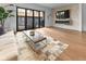 Bright living room with large windows, hardwood floors, and a fireplace at 1818 N Pennsylvania St, Indianapolis, IN 46202