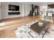 Open living space featuring hardwood floors, fireplace, and modern staircase at 1818 N Pennsylvania St, Indianapolis, IN 46202