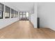 Open-concept living room with hardwood floors and access to an outdoor terrace at 1818 N Pennsylvania St, Indianapolis, IN 46202