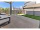 Large concrete patio with adjacent lawn, featuring modern outdoor seating and a detached garage at 1818 N Pennsylvania St, Indianapolis, IN 46202