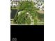 Aerial view of a property with a mix of mature trees, outbuildings, and proximity to neighborhood at 18229 Moontown Rd, Noblesville, IN 46062