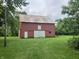 Exterior of a red barn with a rusty tin roof and a large sliding door at 18229 Moontown Rd, Noblesville, IN 46062