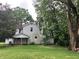 The back exterior of a quaint two-story home with white siding and lush greenery at 18229 Moontown Rd, Noblesville, IN 46062