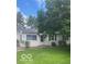 Charming single-story home with lush green lawn and mature trees creating a serene outdoor space at 1882 Knox Dr, Clayton, IN 46118