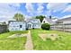 Spacious backyard with grass, a fire pit, and an in-progress garage framed with blue sheeting at 209 E John St, Alexandria, IN 46001