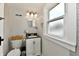 Bright bathroom featuring a white vanity with a dark countertop and a window letting in natural light at 209 E John St, Alexandria, IN 46001
