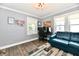Comfortable bedroom featuring a blue leather couch and wood laminate flooring at 209 E John St, Alexandria, IN 46001