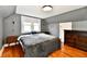 Cozy bedroom with neutral gray walls and a large bed with wood floors at 209 E John St, Alexandria, IN 46001