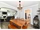 Cozy dining room with wood table, stylish lighting fixture, and open view to the living room at 209 E John St, Alexandria, IN 46001