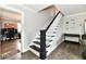 Bright hallway features a modern black and white staircase and wood floors at 209 E John St, Alexandria, IN 46001