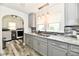 Modern kitchen featuring grey cabinets, granite countertops, mosaic backsplash, and stainless steel sink at 209 E John St, Alexandria, IN 46001
