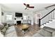 Bright living room features a fireplace, hardwood floors, ceiling fan, and comfortable seating area at 209 E John St, Alexandria, IN 46001