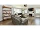 Cozy living room featuring hardwood floors, a white brick fireplace, and comfortable grey sofas at 209 E John St, Alexandria, IN 46001